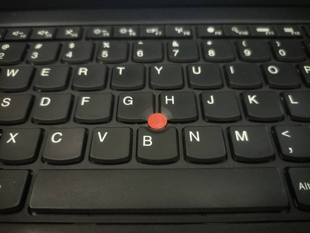 istock Laptop trackpoint. Red trackpoint on a laptop keyboard 2168970370