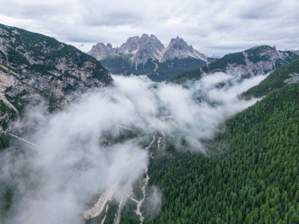 istock Misty Mountain Road with Dense Forest in Alpine Landscape 2168971431