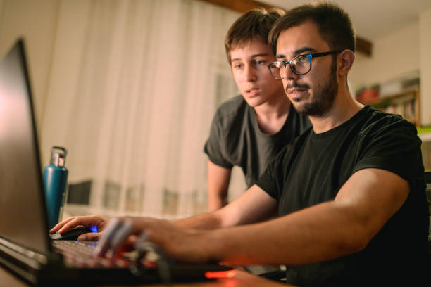 istock Family playing computer game together on laptop at home. 2168971553