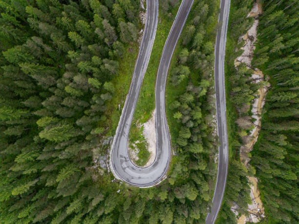 istock Curving Mountain Road Through Lush Forest Aerial View 2168971972