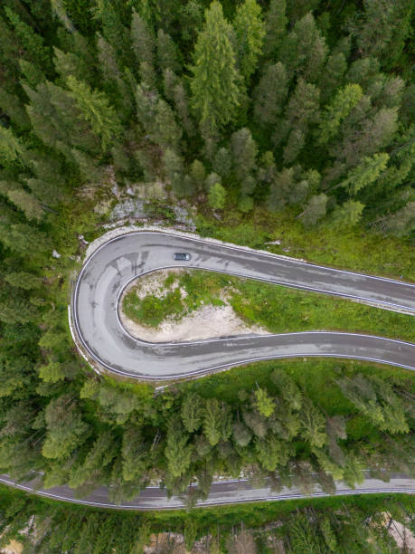 istock Hairpin Turn on Mountain Road Surrounded by Dense Forest 2168972529