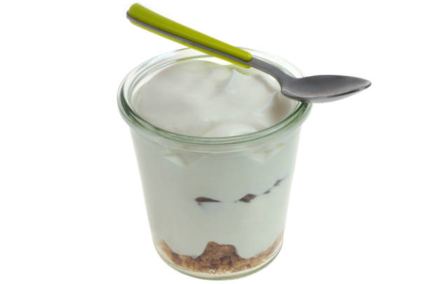 Homemade dessert with whipped cream and crumble close-up on white background