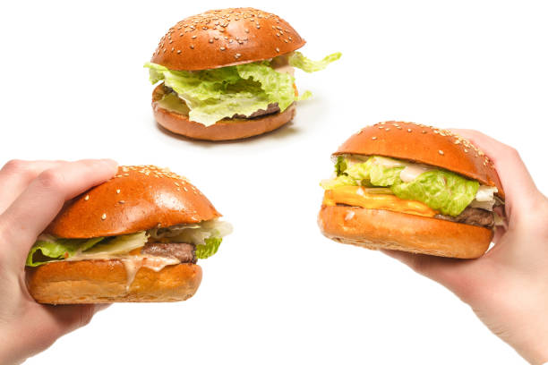 istock Hamburger in woman hands isolated on a white background. 2168973918