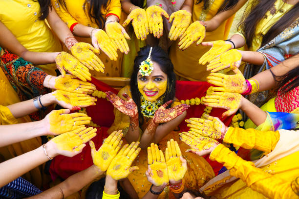 Portrait Of Smiling Bride Amidst Women During Haldi Ceremony Photo taken in Gujarat International Finance Tec-City, India haldi ceremony stock pictures, royalty-free photos & images