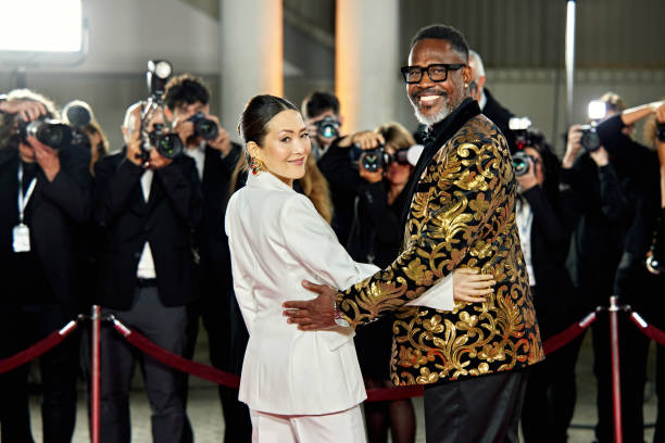 istock Celebrity couple turning to smile at camera 2168976468