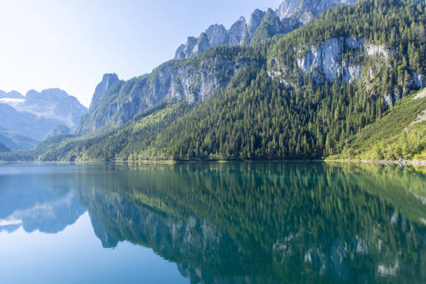 istock Crystal Clear Alpine Lake Reflecting Majestic Mountains 2168976556
