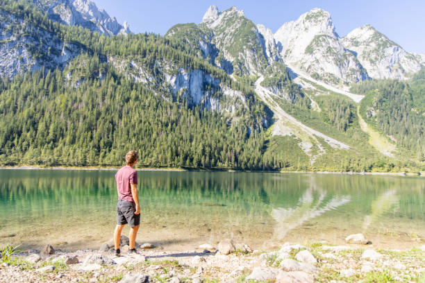 istock Man Walking by a Serene Mountain Lake 2168979162