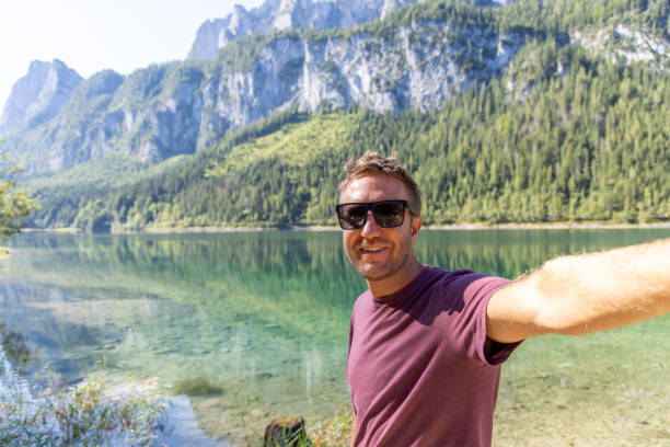 istock Man Taking a Selfie by a Scenic Mountain Lake 2168979181