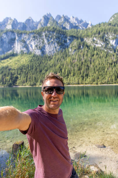 istock Man Taking a Selfie by a Scenic Mountain Lake 2168979190