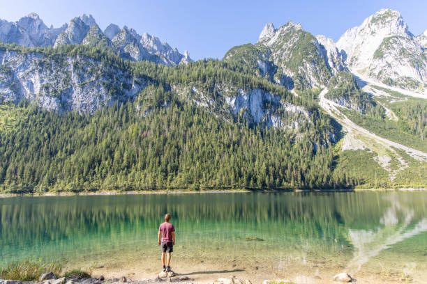 istock Man Admiring Scenic Mountain Lake 2168979332