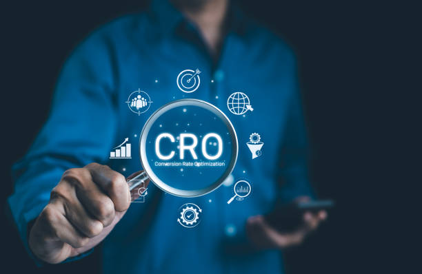 istock CRO, Conversion Rate Optimization Concept. Businessman holding magnifying glass focusing on the text 