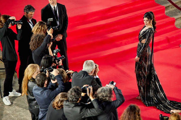 istock Female celebrity posing for pictures on red carpet 2168980582