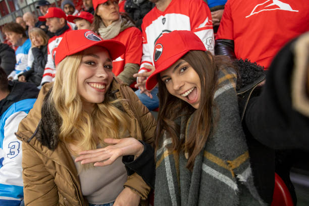 istock Two Young Women Posing Cheerfully at a Sporting Event 2168983718