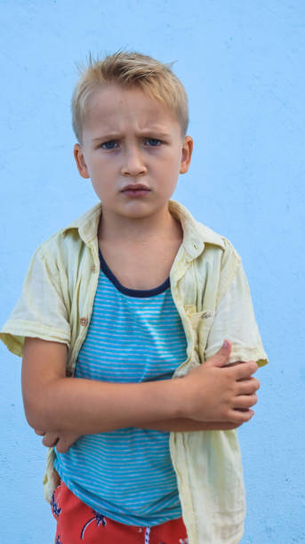 blond boy in bad mood close-up