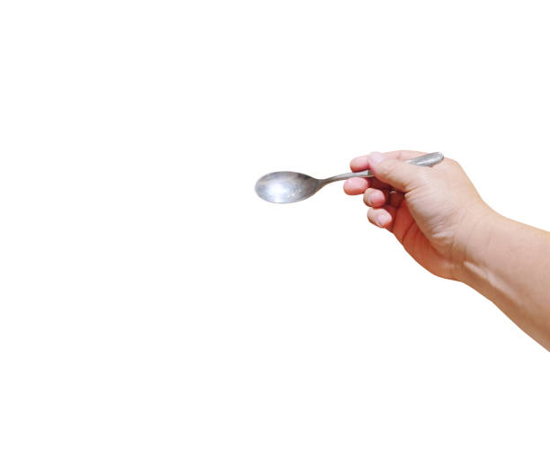 istock Man holding a shiny new spoon on a white background. 2168984687