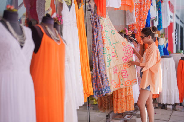Solo travelling woman shopping in a touristic place in summer.