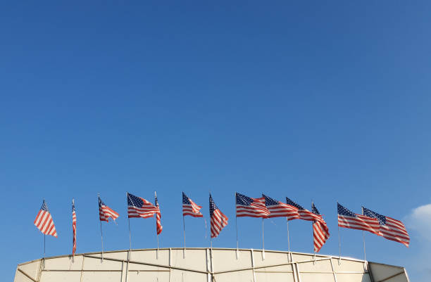 istock many american flags over blue sky 2168988682