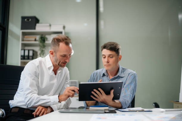 istock Two business workers talking on the smartphone and using laptop 2168992204