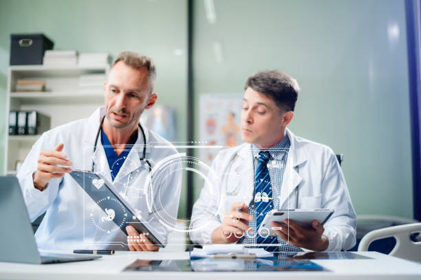 istock Diverse team of doctors and specialists brainstorming with digital tools, discussing test results and planning in hospital 2168992339