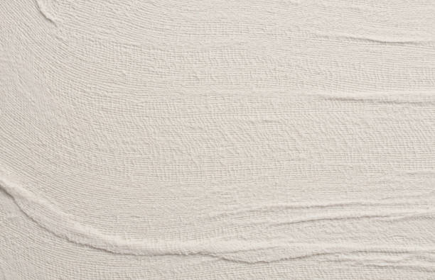 istock Empty crumpled wet craft canvas fabric blank texture copy space wave background. Gray beige pastel color. 2168993118