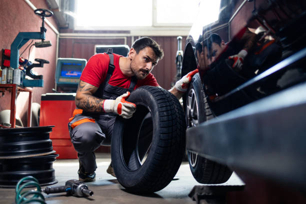 istock Tire repairman installing a new tire on a car. 2168995635
