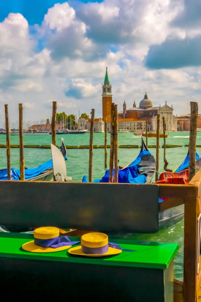Gondoliers hats with famous gondolas in Venice, Italy.