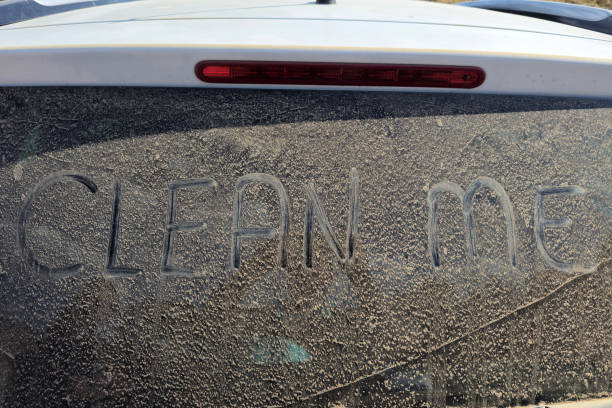 A dirty car driving through muddy roads after a rainy day