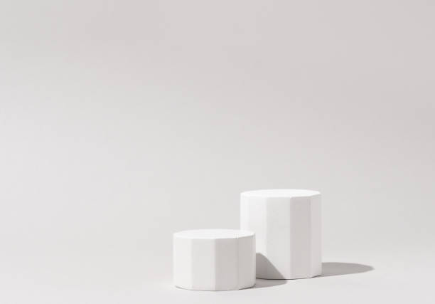 istock Cosmetics product presentation background scene made with two white pillars podium stage in sunlight. Ideal for showcasing cosmetics, perfumery, jewelry and modern branding visuals. Studio photography. 2169000383