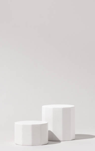 istock Cosmetics product presentation background scene made with two white pillars podium stage in sunlight. Ideal for showcasing cosmetics, perfumery, jewelry and modern branding visuals. Vertical photography. 2169000384