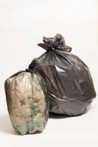 istock plastic trash bags on white background, black plastic garbage bags on white background 2169006532