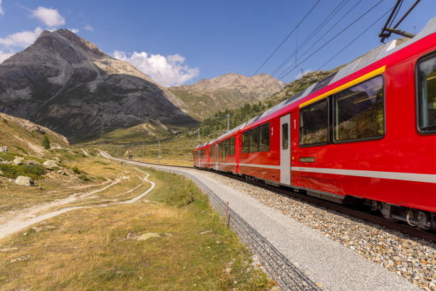 istock Red Train Winding Through Mountainous Terrain 2169007812