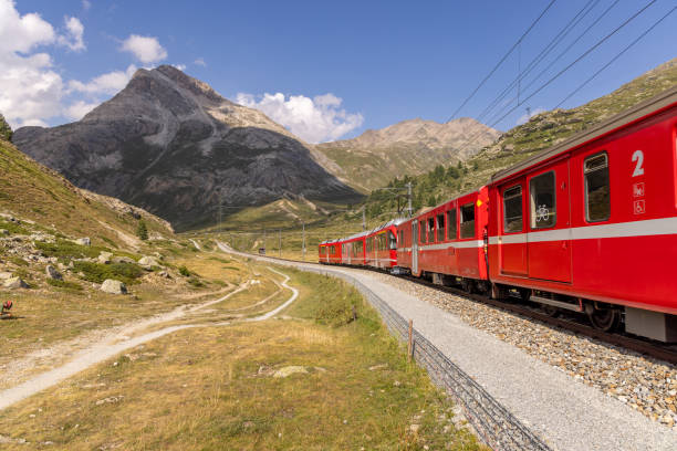 istock Red Train Winding Through Mountainous Terrain 2169007823