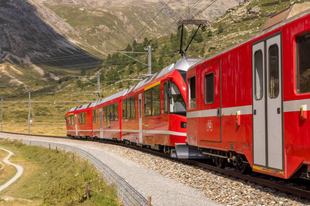 istock Red Train Winding Through Mountainous Terrain 2169007873