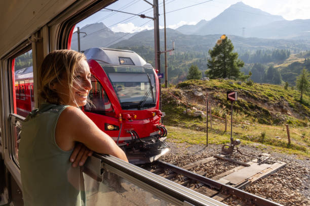 istock Smiling Woman on Train Enjoying Scenic Mountain View 2169008415