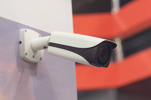 istock Surveillance camera is hanging on the wall 2169011755
