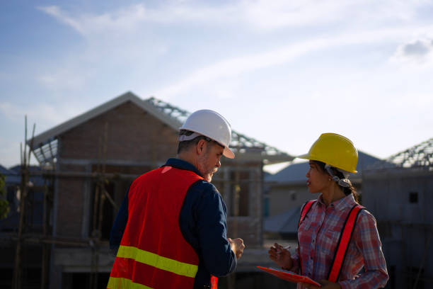 istock Blue collar workers are building house. 2169011979
