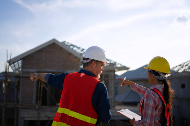 istock Blue collar workers are building house. 2169011991