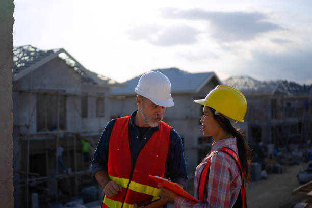 istock Blue collar workers are building house. 2169012050