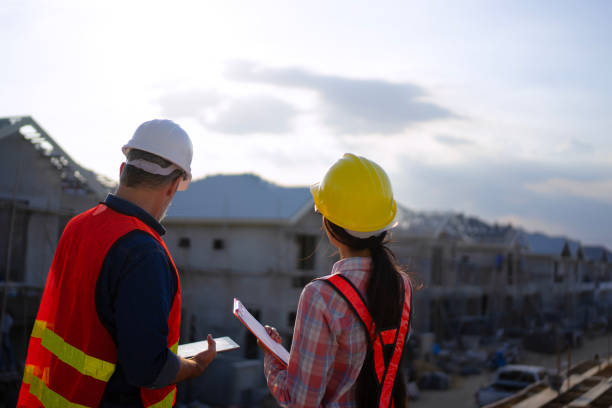 istock Blue collar workers are building house. 2169012057