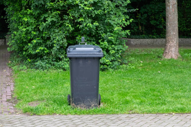 istock Isolated rubbish container on green grass. 2169015520