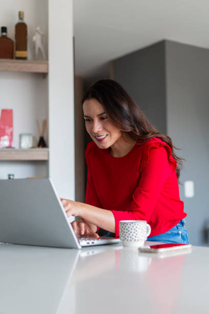 istock Woman works from home while using technology equipment to stay online 2169016642