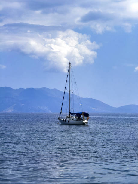 istock Sailing boat navigate on rippled sea, blue sky background 2169016869