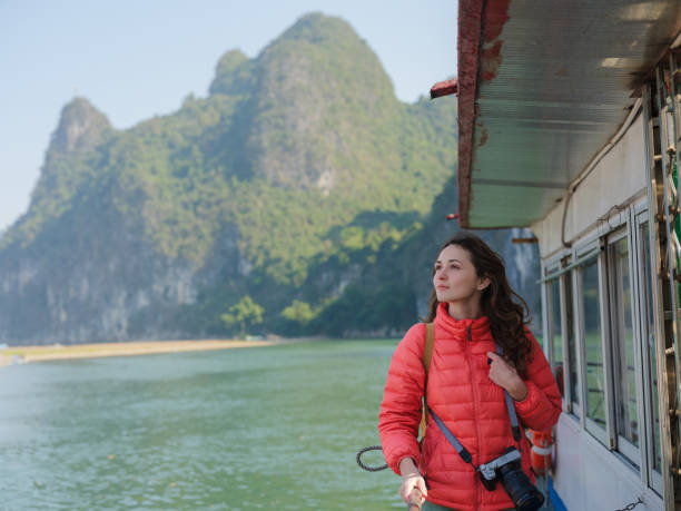 Serene woman  on river cruise on Li river in Guilin,  China