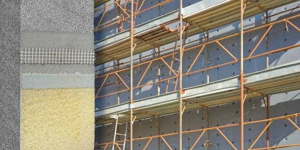 istock CONSTRUCTION SITE FOR THE CONSTRUCTION OF A POLYSTYRENE HEAT-INSULATING COATINGS to improve the energy efficiency of buildings with metal scaffolding 2169020713