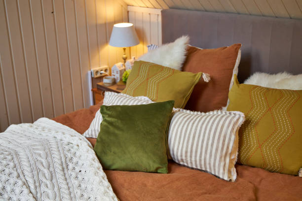 istock Decor of a double bed with colorful pillows in modern style 2169022106