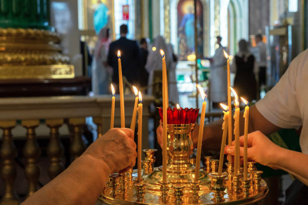 istock People light prayer candles during church services. 2169024784
