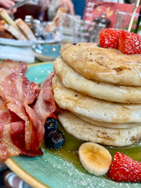 istock Delicious Thick Stack of Blueberry Pancakes with Maple Syrup and Fresh Fruit Blueberries Strawberries and Banana at Bill’s Restaurant Food Brunch Breakfast Meal Gluten Free Celiac Coeliac Disease 2169025706