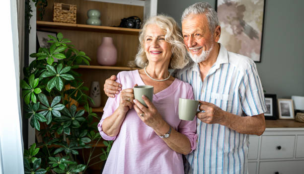 istock Senior couple drinking coffee together at home 2169029744