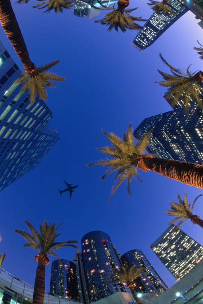 USA, California, Downtown towers with Jet plane passing.