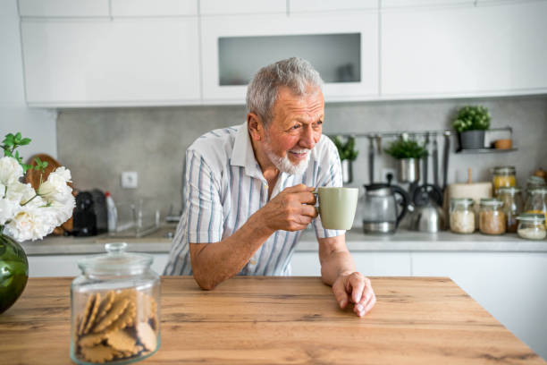 istock Cheerful senior man drinking first morning coffee 2169030329